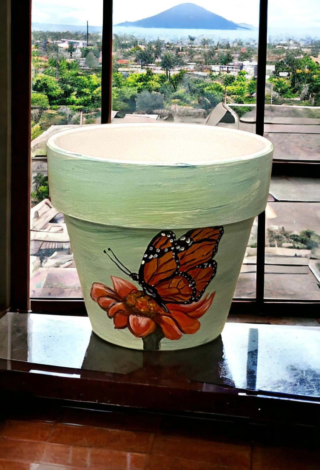 Emerald Blossoms -  A beautiful butterfly and a sunflower with green background hand-painted on a terracotta pot.